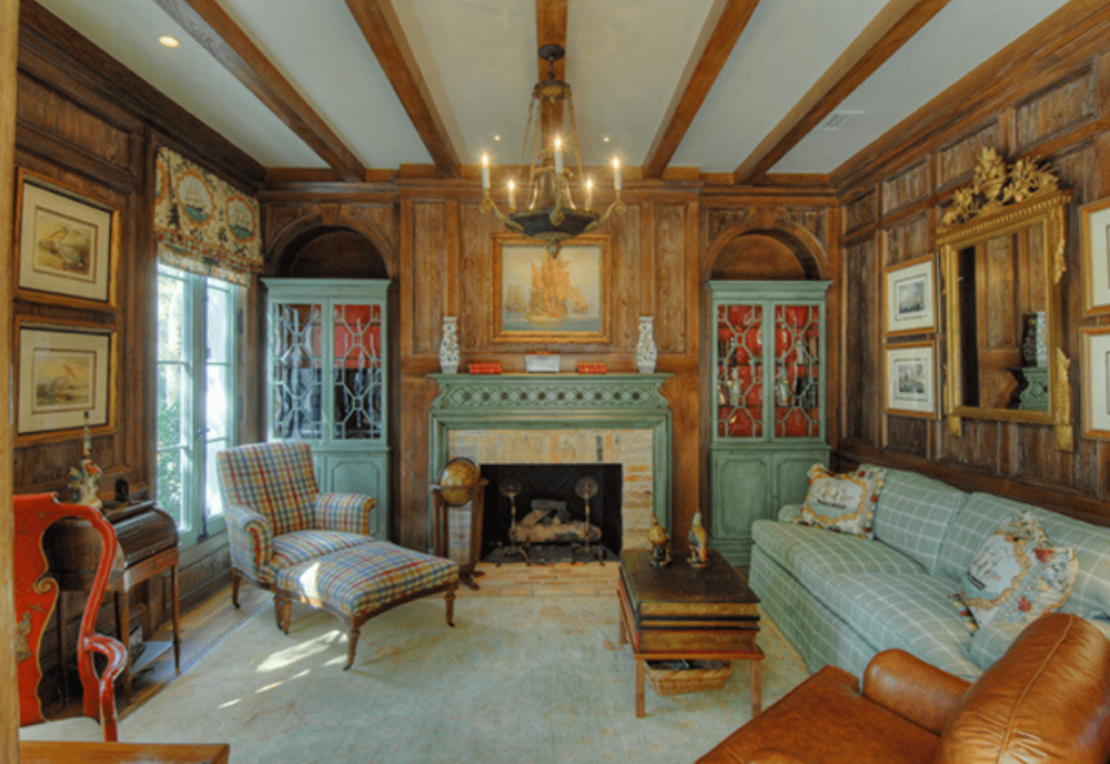 luxury den with fireplace and wood beam ceilings