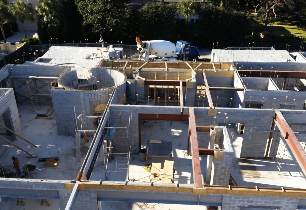 drone shot of house being built sea island